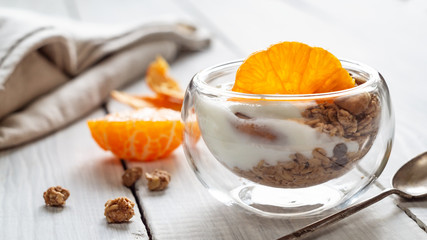 Healthy organic light breakfast. Granola, yogurt and mandarin