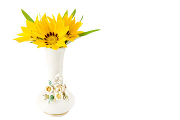 Yellow gazinia flower (Gazania reagens) with leaves  in a retro vintage vase and space for your text isolated on white background.