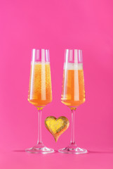 Valentines day background with champagne glasses and gold heart