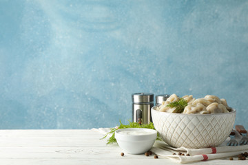 Composition with dumplings and spices on wooden table, space for text