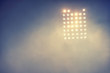 Fototapeta premium stadium lights and smoke against dark night sky background