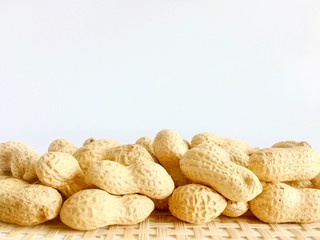 White background with lots of peanuts on the bottom of the frame.