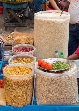 Local street food stall. Bhel puri or poori is one of the most popular spicy snacks sold in Mumbai, Maharashtra, Central India. It is a mixture of puffed rice, sev and numerous other ingredients. 