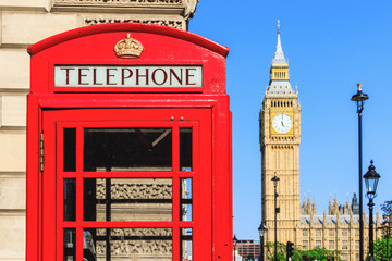 Fototapeta na wymiar Red telephone box with Big Ben against blue sky in the background