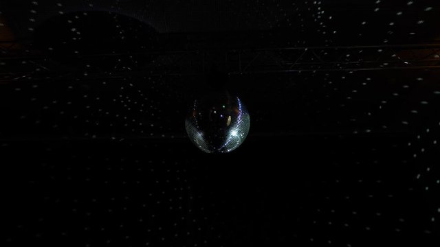 Disco Ball Reflecting Light on Dark Background