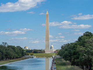 Obraz premium Washington, District of Columbia, United States of America - Washington monument park, obelisk on national mall, American flags and US capitol