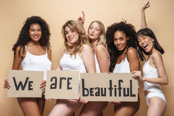 Image of young multinational women making fun and holding placards