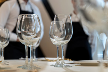 Chic and elegant, gold-plated cutlery and white plates, table setting with empty plates.