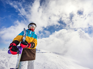 Portrait of woman snowboarder on background beautiful landscape of snowy high mountains of Caucasus...