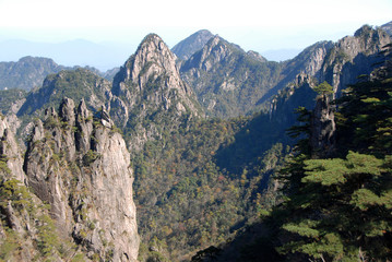 Fototapeta na wymiar Huangshan Mountain in Anhui Province, China. A beautiful panoramic mountain view of the rocky peaks of Huangshan at White Goose Ridge. From a viewpoint near the summit of Huangshan Mountain, China.