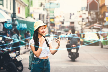 Asian woman using smartphone at Khaosan Road - obrazy, fototapety, plakaty