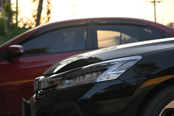 Fototapeta na wymiar closeup headlight led of black modern car in the morning scene
