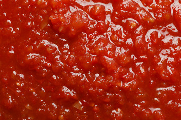 Chili sauce textured background, top view, closeup. Space for text