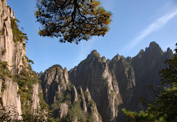 Huangshan Mountain in Anhui Province, China. View of mountain peaks, cliffs and trees at the lower part of West Sea or Xi Hai canyon on Huangshan. From the West Sea path on Huangshan Mountain, China.