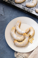 Russian crumbly cookies, similar in shape to a croissant, called roguelike with sweet jam. Homemade sweet pastries on a baking sheet