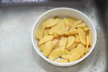 Boiled potatoes cut into beautiful pieces, placed in a cup for cooking.