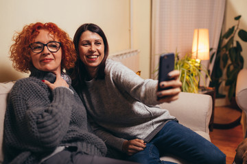 two woman friends having great afternoon together at home