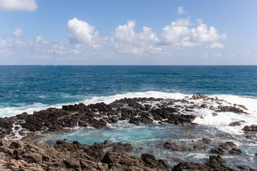 Fototapeta na wymiar Sainte-Anne, Martinique, FWI - Waves in the blue eye hole (oeil bleu) in Ferré Cape