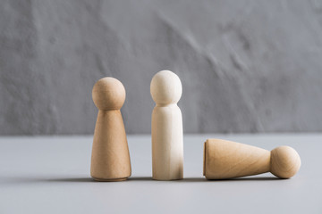 Love triangle concept. One wooden men and two woman. Divorce. Treason.