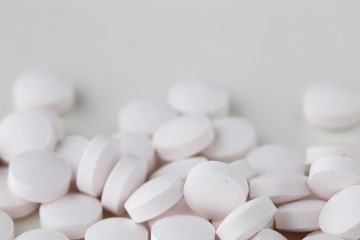 Fototapeta na wymiar Pills tablets vitamins capsules drugs white close up macro shot
