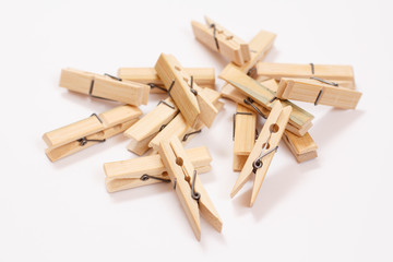 Set of wooden clothes pins on white background