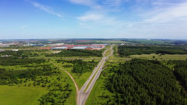 landscape with highway between meadows near plant aerial