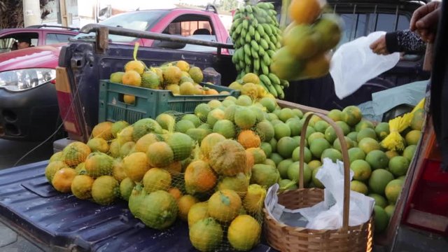 Fruit and vegetables get picked up at a street market in Brazil on a Sunday morning