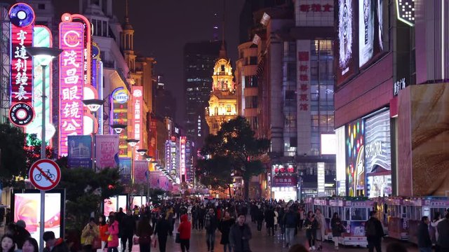 SHANGHAI, CHINA - DEC 22, 2019 : Nanjing Road is the main shopping streets of Shanghai, Neon signs light on Nanjing Road. The area is the main shopping district of the city and one of the world's busi