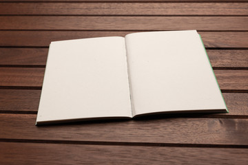 Blank notebook on wooden background, mockup