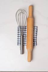 whisk and rolling pin on a white background