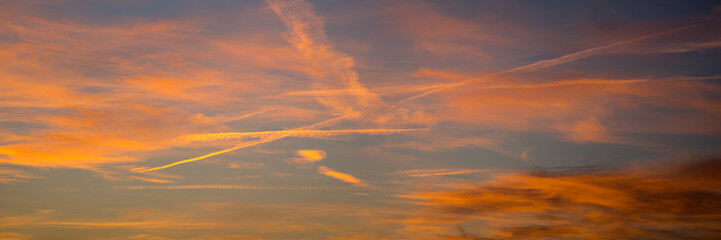 Dramatic red yellow and blue sky at dusk the setting of the evening, panorama