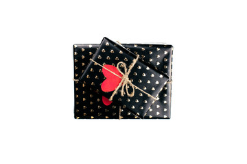 Fototapeta premium Gift boxes wrapped in black paper with hearts flat lay on white background with copy space. 8 march, Mother's day, Valentine's Day gifts top view. Celebrate concept. Template for web. Stock photo.