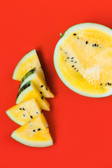 cut off triangular slices of ripe yellow watermelon on white background