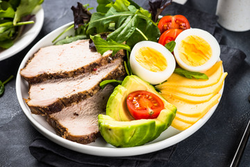 Keto diet plate on black stone table.