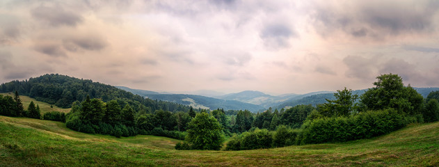 Fototapeta na wymiar Wide panorama of an idyllic mountain landscape on a cloudy day (photomerge image)