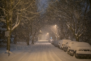 Downtown of a city after snow storm in Vancouver Canada British Columbia  fresh snow with high rise building in background skyscraper at night 