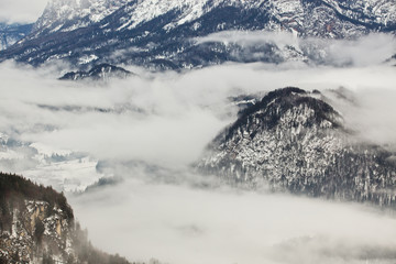 Fototapeta na wymiar Beautiful fog in the high, rocky mountains in winter.