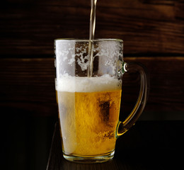 beer is poured into a beer mug