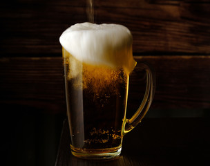 beer is poured into a beer mug