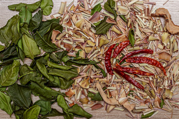 Set of spices for cooking Tom Yam: galangal, chili, lime and lemongrass. Beautiful background to decorate the kitchen.