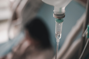 Close up set iv fluid intravenous drop saline drip for accident and seriously patient in hospital room.Medical treatment emergency patient