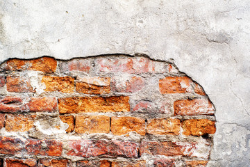 Brick red wall with exfoliated gray plaster