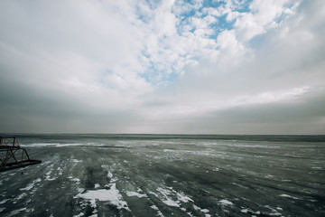 frozen water blue-green ice on the river. winter landscape with a pond.
