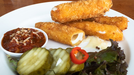 Cheese stick fired on the plate with vegetable for decorate, din.