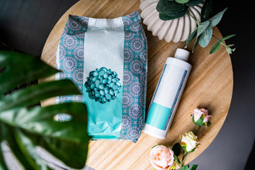 Transparent packet of Seal Wax Beads. Bright colored granules. Wooden background.Pearls wax for...