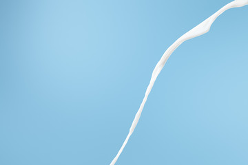 fresh flowing white milk isolated on blue