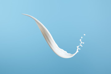 Obraz na płótnie Canvas fresh white milk splash isolated on blue