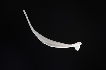 fresh white milk splash isolated on black