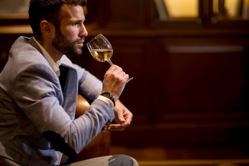 View at young man tasting white wine