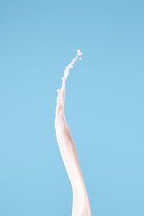 Fototapeta premium smooth fresh pink milk splash isolated on blue